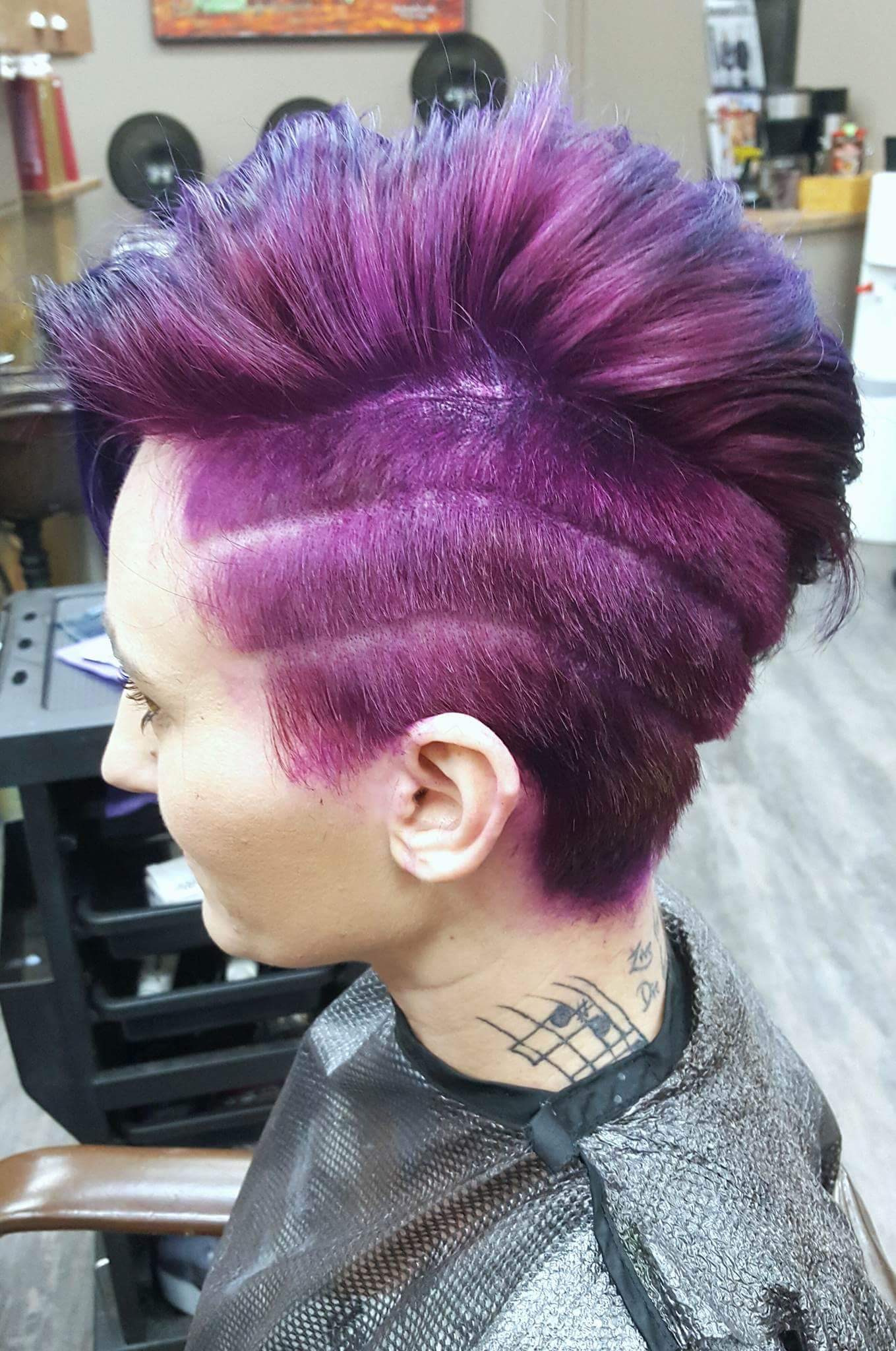 Female customer with bright purple haircut at hairstyle inn Saskatoon