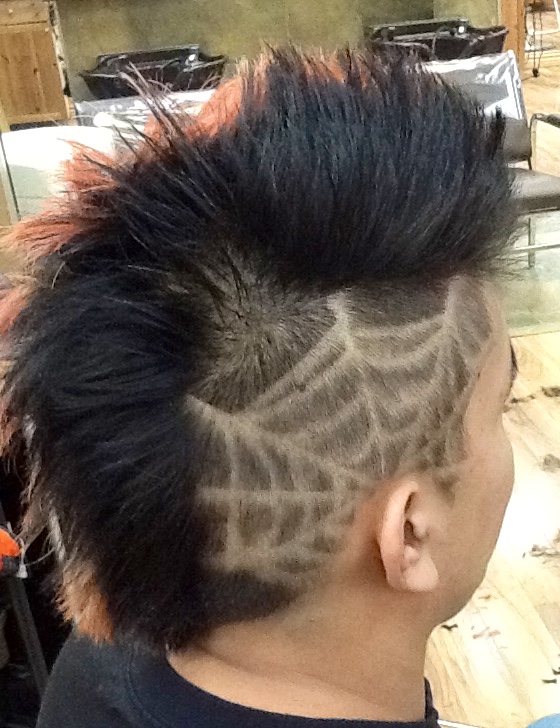 Side view of male customer hair cut with tattoo at hairstyle inn