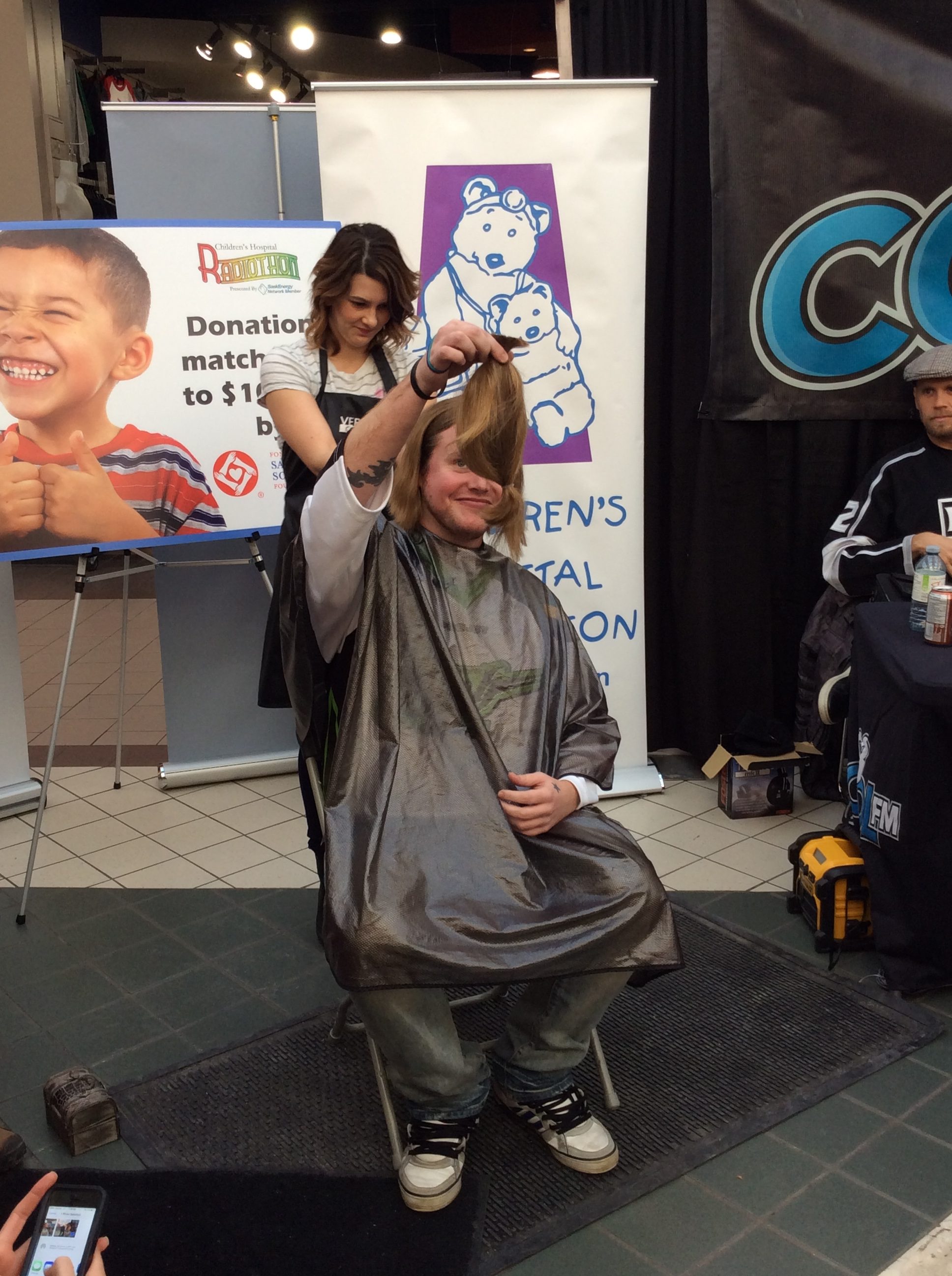 Female customer having her hair cut for donation at hairstyle inn