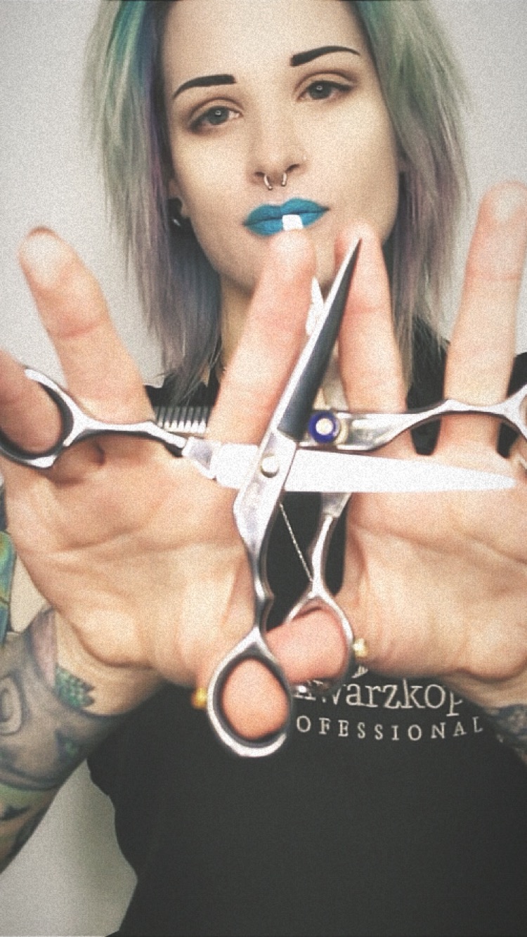Hairstyle inn female stylist displaying professional hair stylist scissors