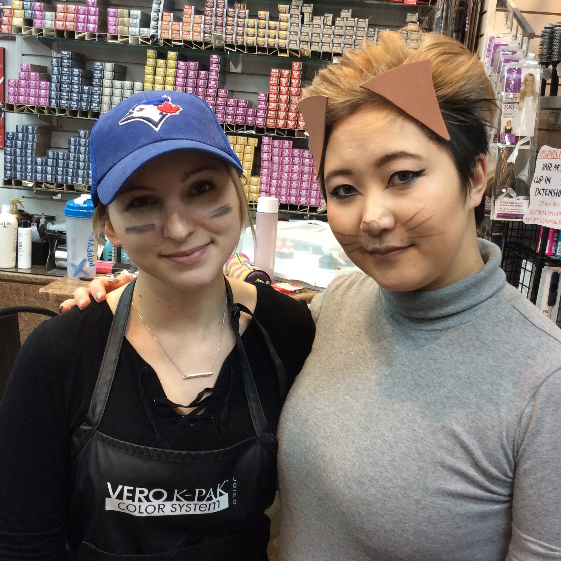 Two female stylist of hairstyle inn dressed in Halloween costumes